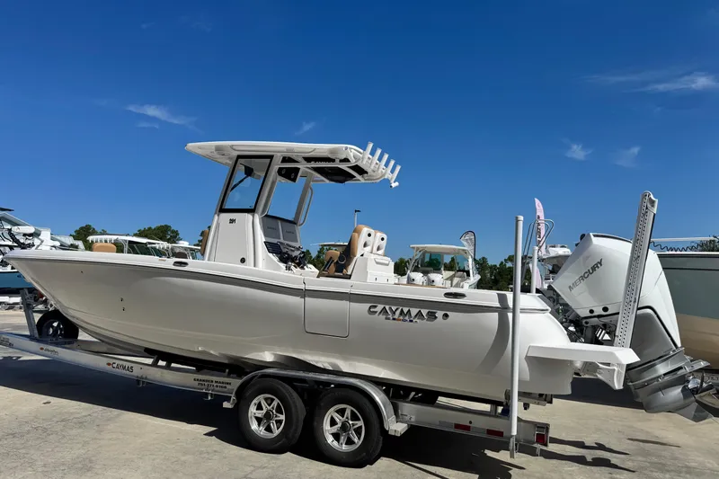 Slide: The Image of 2026 Caymas 291 boat on trailer under clear blue sky. - 3