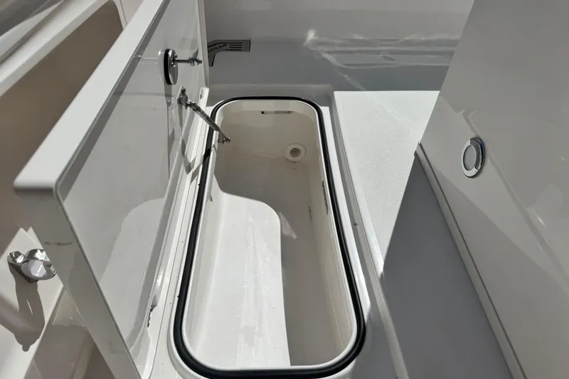 Slide: The Image of Open storage compartment on 2026 Caymas 291 boat, showcasing sleek design and functionality. - 30