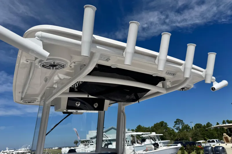 Slide: The Image of 2026 Caymas 291 boat with rod holders and speakers under a clear blue sky. - 34