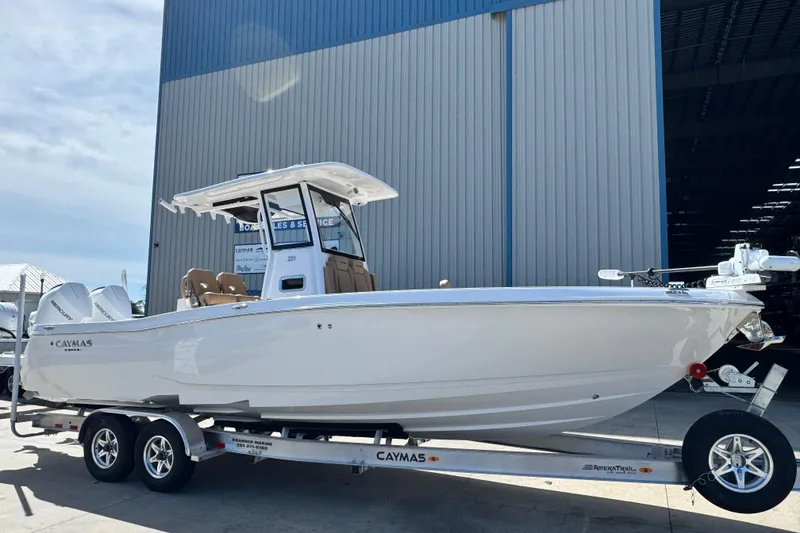 Slide: The Image of 2026 Caymas 291 boat on trailer outside a large warehouse. - 7