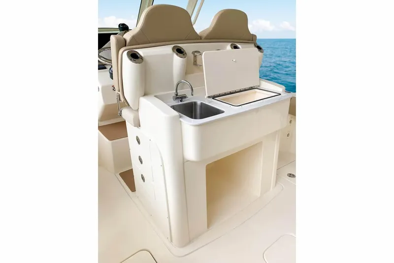 Slide: The Image of Manufacturer Provided Image: 2025 Scout 305 LXF boat interior with sink and storage area. - 7