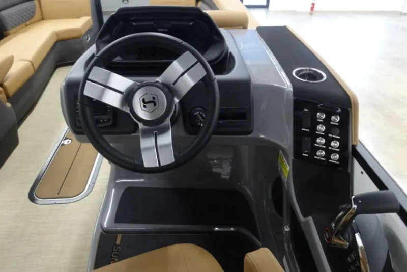 Slide: The Image of 2026 Harris Sunliner 250 boat dashboard with steering wheel and control panel. - 12