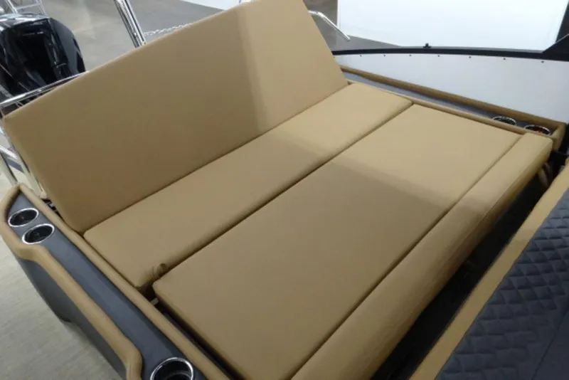 Slide: The Image of 2026 Harris Sunliner 250 boat with tan cushioned seating and cup holders. - 15