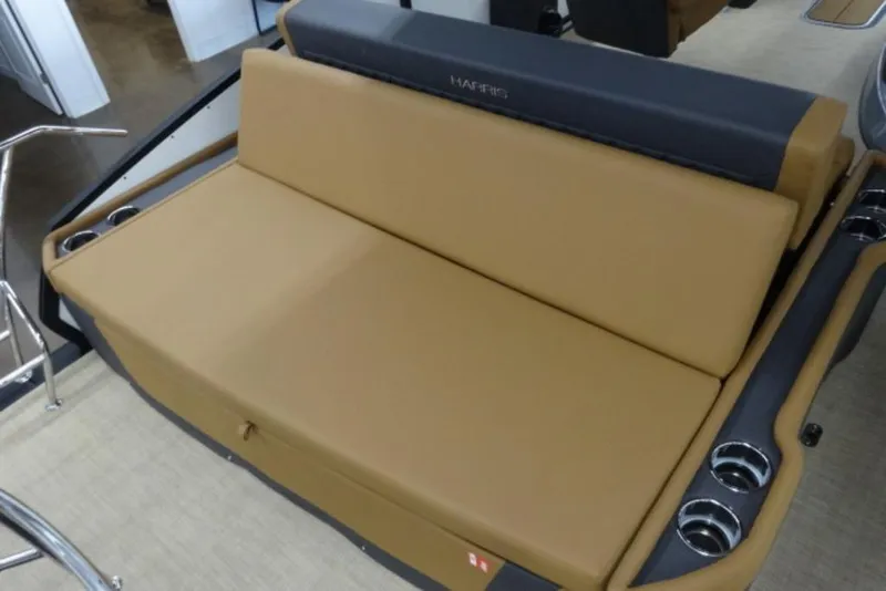 Slide: The Image of 2026 Harris Sunliner 250 boat seating with tan upholstery and integrated cup holders. - 16