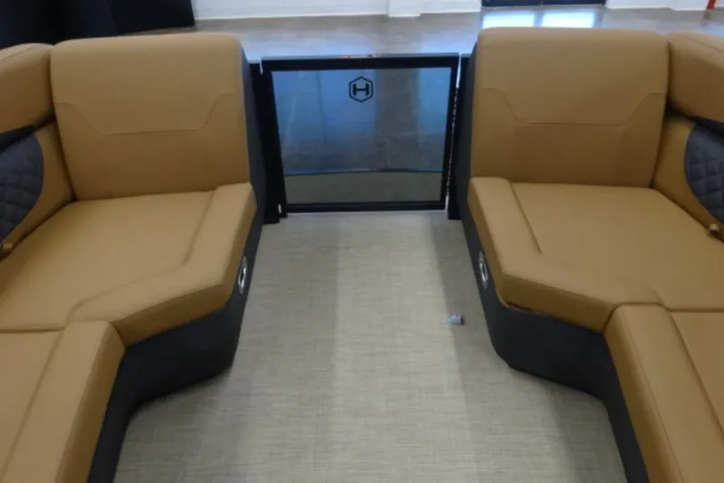 Slide: The Image of 2026 Harris Sunliner 250 interior with tan seating and modern design. - 18