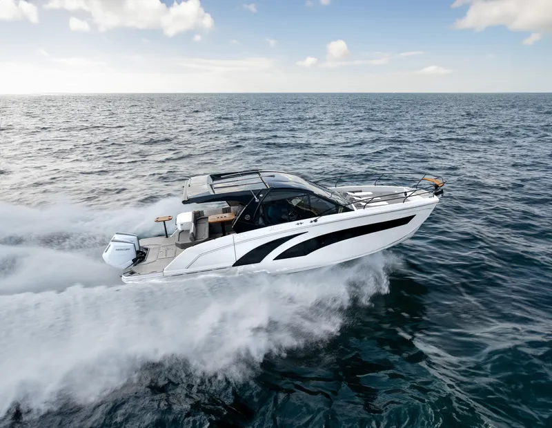 Slide: The Image of 2025 Hanover 387 boat cruising swiftly on open sea under clear skies. - 0