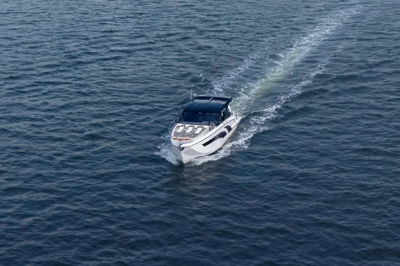 Slide: The Image of Aerial view of 2025 Hanover 387 boat cruising on open water. - 1