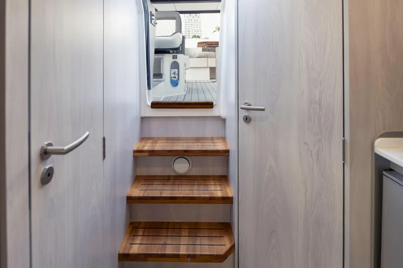 Slide: The Image of Interior view of 2025 Hanover 387 yacht, featuring wooden stairs and modern design. - 20