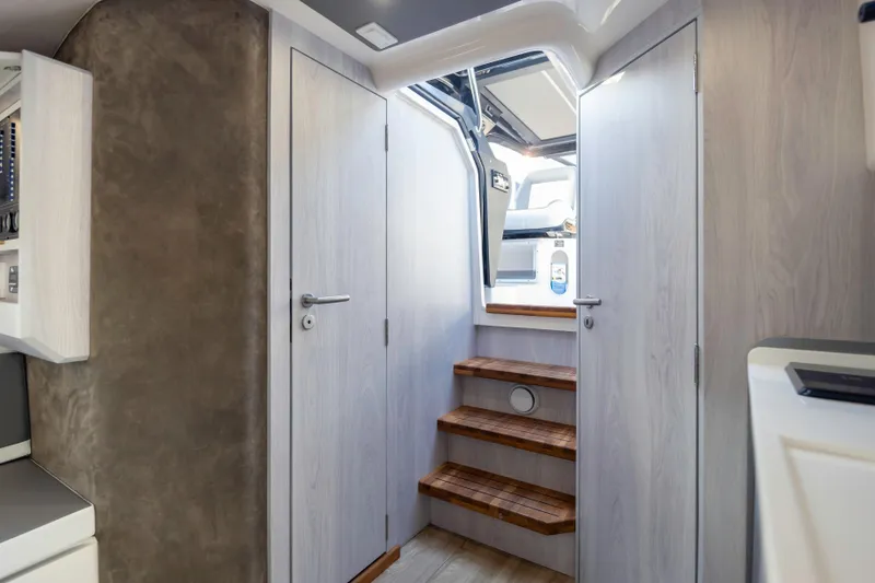 Slide: The Image of Interior of 2025 Hanover 387 RV with wooden steps and modern design. - 21