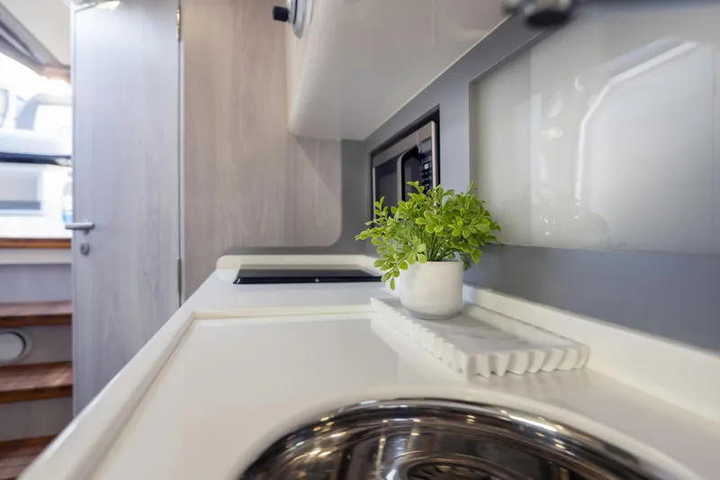 Slide: The Image of Modern kitchen interior in 2025 Hanover 387, featuring sleek design and potted plant. - 25