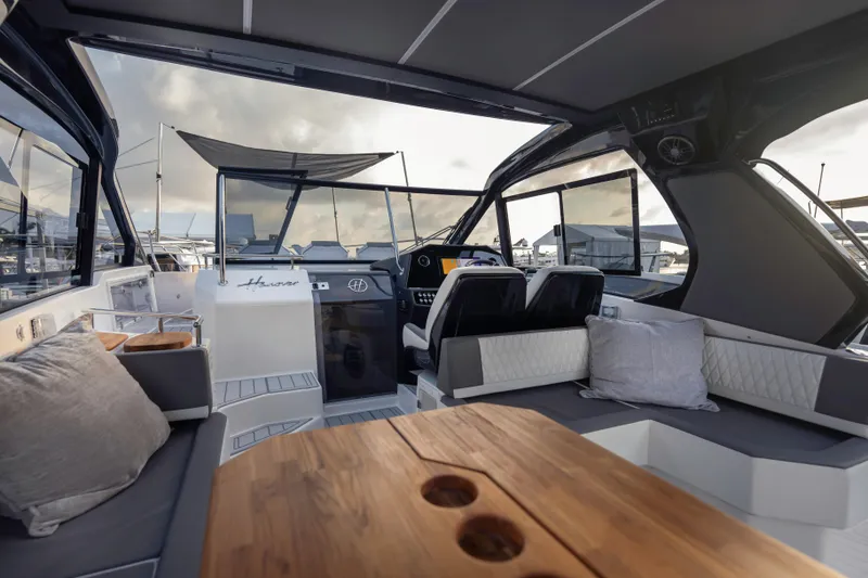 Slide: The Image of Luxurious interior of 2025 Hanover 387 yacht with modern seating and wooden table. - 5