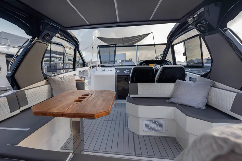 Slide: The Image of Luxurious interior of 2025 Hanover 387 yacht with elegant seating and wooden table. - 6
