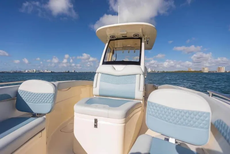 Slide: The Image of Manufacturer Provided Image: 2025 Scout 260 LXF boat interior with blue seating on a sunny day. - 5