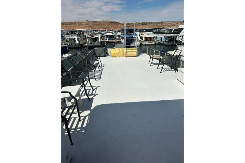 Slide: The Image of Spacious deck of 1988 Lazy Days houseboat with seating, docked in a marina. - 15