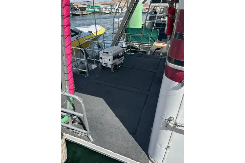 Slide: The Image of Houseboat deck with generator, docked near other boats, Lazy Days model, 1988. - 18