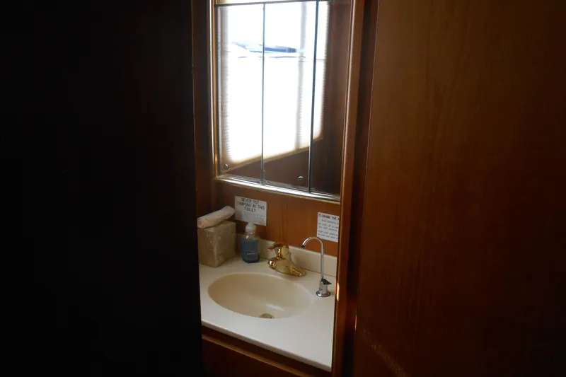 Slide: The Image of Small bathroom on 1988 Lazy Days houseboat with sink, mirror, and toiletries. - 19