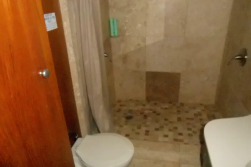 Slide: The Image of Bathroom interior of 1988 Lazy Days houseboat with tiled shower and toilet. - 21