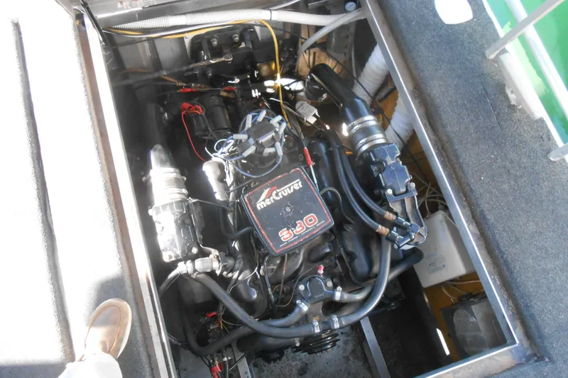 Slide: The Image of Engine compartment of a 1988 Lazy Days houseboat, featuring a MerCruiser 5.0 engine. - 24