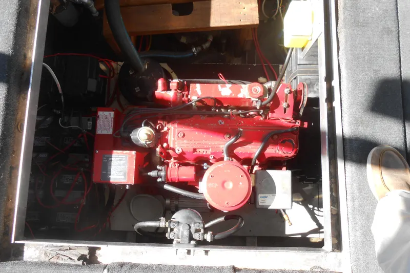 Slide: The Image of Engine compartment of a 1988 Lazy Days houseboat, featuring a red engine and wiring. - 25