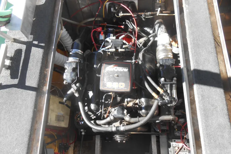 Slide: The Image of Engine compartment of a 1988 Lazy Days houseboat, featuring a MerCruiser engine. - 26