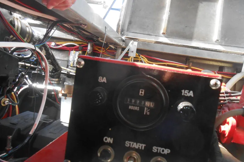 Slide: The Image of Control panel of a 1988 Lazy Days houseboat engine compartment with wiring and gauges. - 27