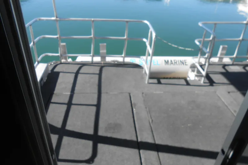 Slide: The Image of Houseboat deck overlooking calm water, featuring railing and marine equipment. - 32