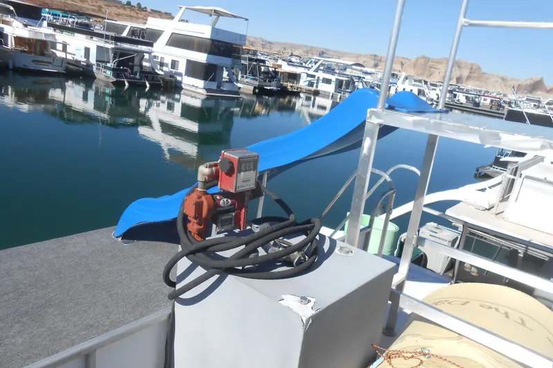 Slide: The Image of 1988 Lazy Days houseboat with blue slide, docked in a marina. - 34
