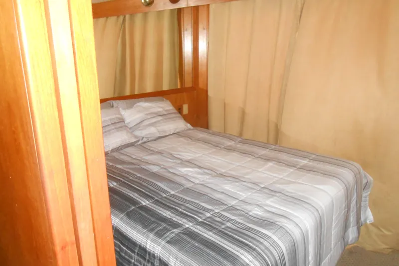 Slide: The Image of Cozy bedroom with striped bedding on 1988 Lazy Days houseboat. - 9