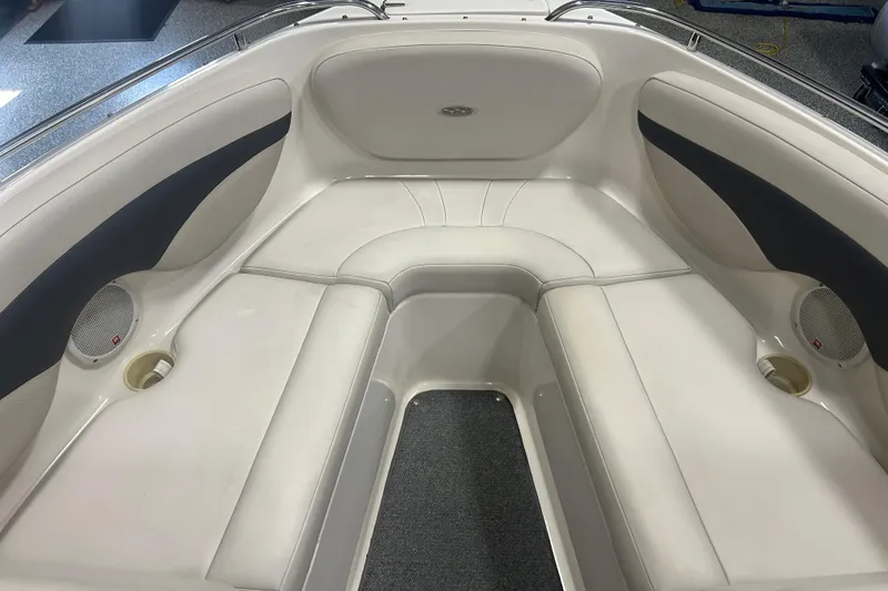 Slide: The Image of 2004 Chaparral 204 SSi boat interior with white cushioned seating and built-in speakers. - 11