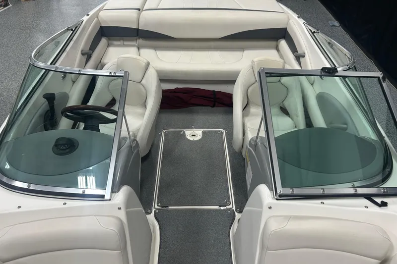 Slide: The Image of 2004 Chaparral 204 SSi boat interior with white seating and dual windshields. - 12