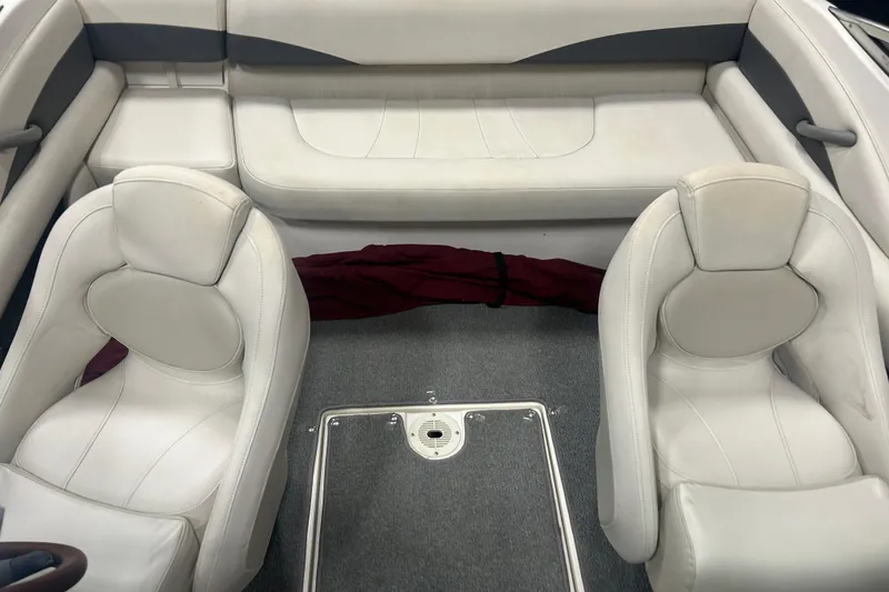 Slide: The Image of 2004 Chaparral 204 SSi boat interior with white seating and carpeted floor. - 13