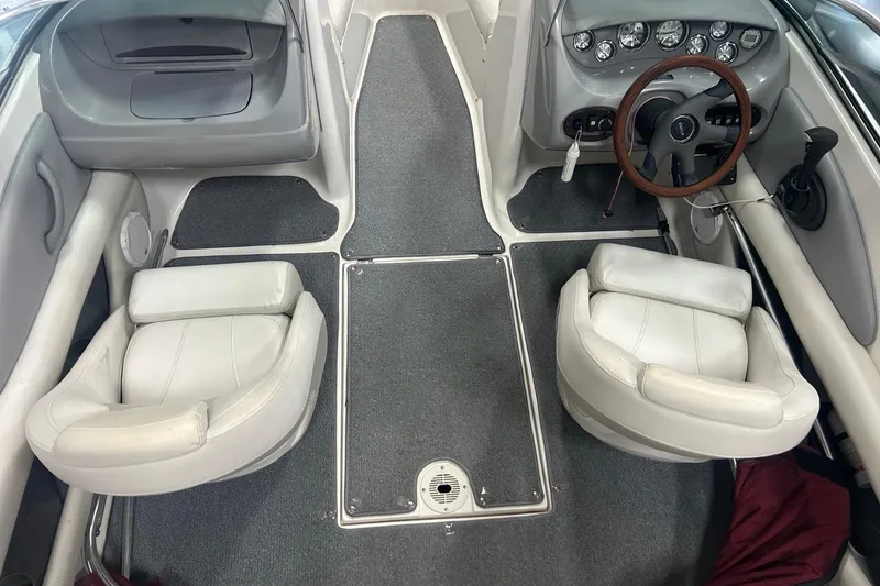 Slide: The Image of 2004 Chaparral 204 SSi boat interior with gray carpet and white seating. - 8