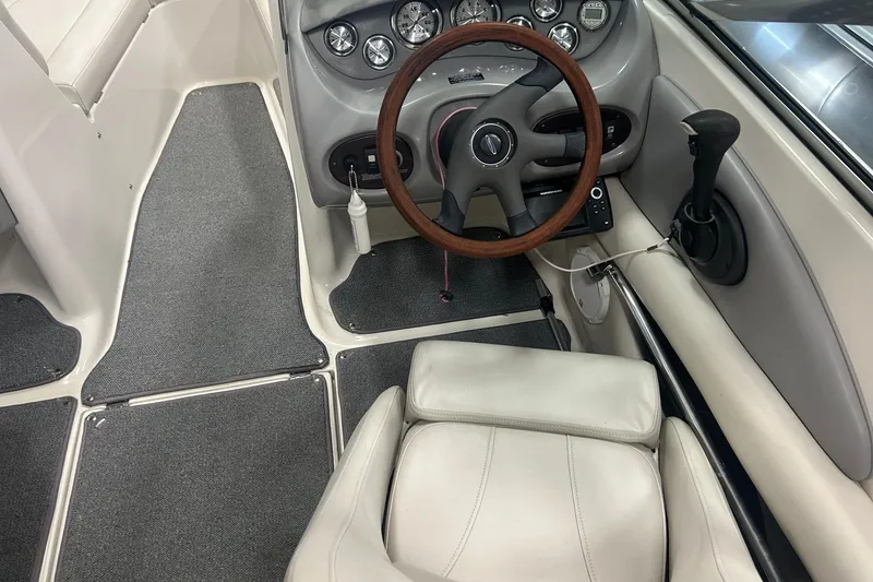Slide: The Image of 2004 Chaparral 204 SSi boat interior with steering wheel and dashboard controls. - 9