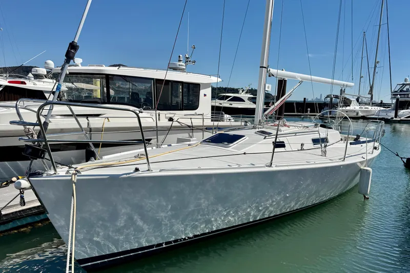 Slide: The Image of 1999 J Boats J/105 sailboat docked in marina under clear blue sky. - 0