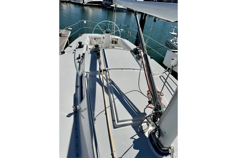 Slide: The Image of 1999 J Boats J/105 sailboat deck with rigging, docked in marina. - 10