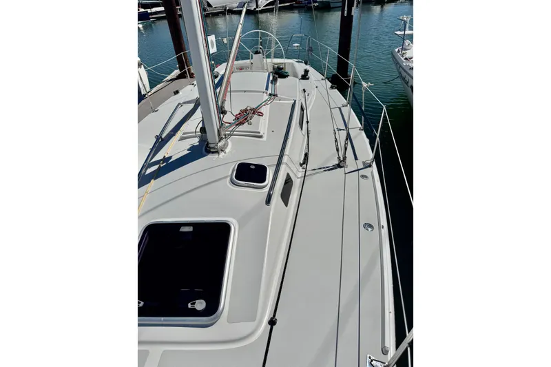 Slide: The Image of 1999 J Boats J/105 sailboat deck view at marina, showcasing sleek design and rigging. - 11