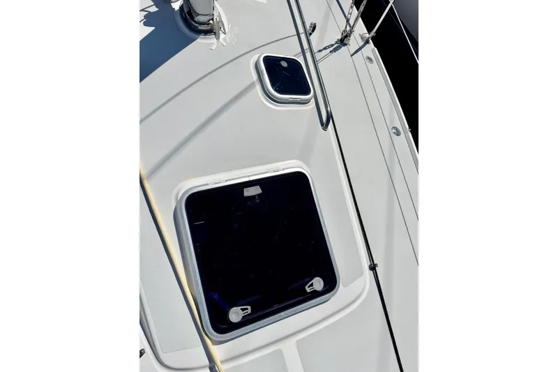 Slide: The Image of Deck view of a 1999 J Boats J/105 sailboat, featuring hatches and rigging. - 13