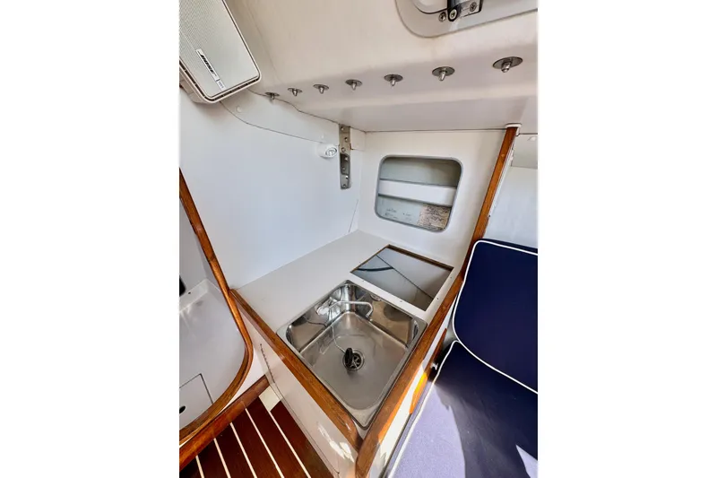 Slide: The Image of Interior of 1999 J Boats J/105 sailboat featuring a compact galley with sink. - 18