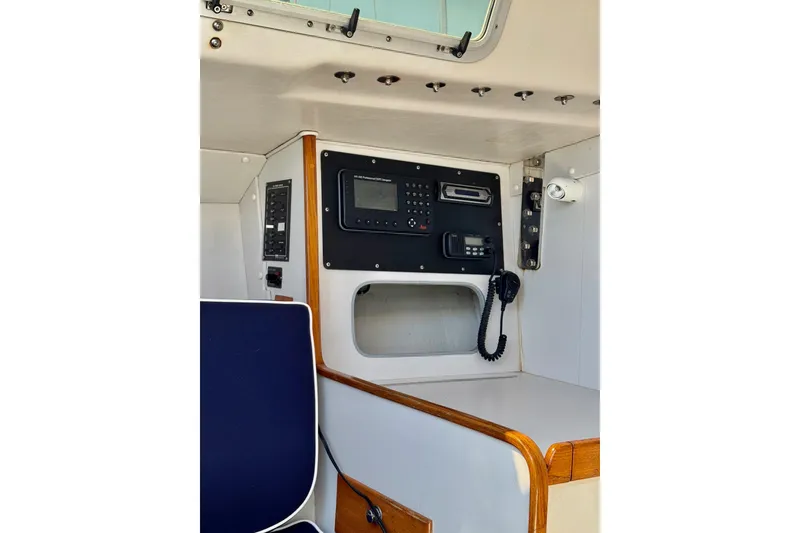 Slide: The Image of Interior of 1999 J Boats J/105 sailboat showing navigation equipment and seating area. - 20