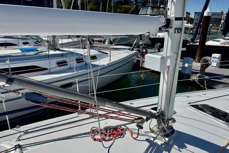 Slide: The Image of 1999 J Boats J/105 sailboat docked at marina, featuring rigging and deck details. - 23