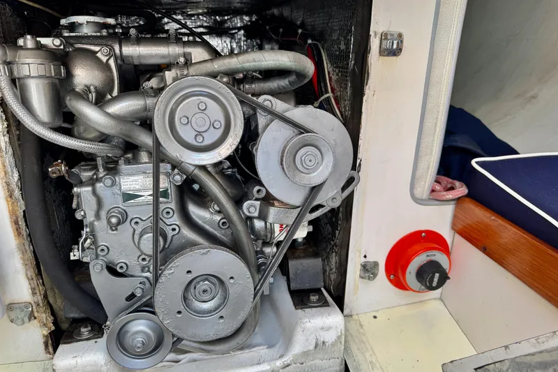 Slide: The Image of Engine compartment of a 1999 J Boats J/105 sailboat, showing mechanical components and wiring. - 25