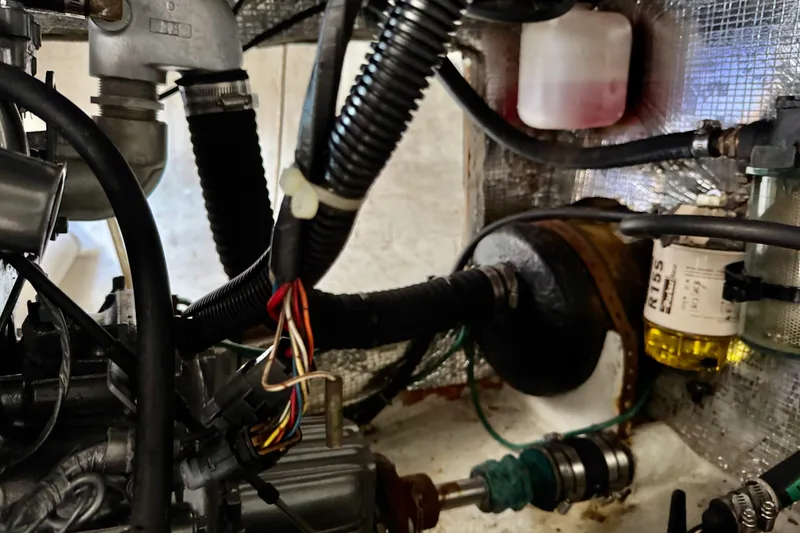 Slide: The Image of Engine compartment of a 1999 J Boats J/105 sailboat, showing hoses and wiring. - 29