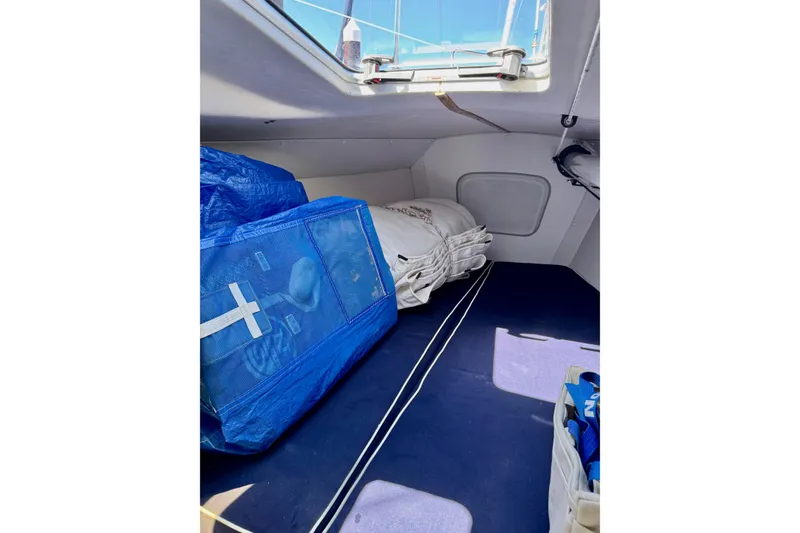Slide: The Image of Interior of 1999 J Boats J/105 sailboat with blue and white sails stored. - 36