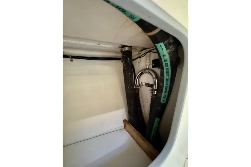 Slide: The Image of Interior view of a 1999 J Boats J/105 sailboat, showcasing plumbing and wiring components. - 38