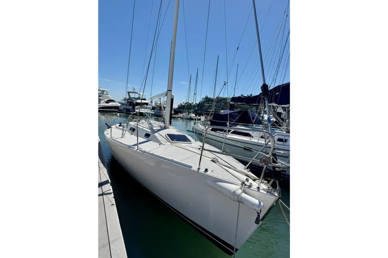 Slide: The Image of 1999 J Boats J/105 sailboat docked in a marina under clear blue skies. - 4