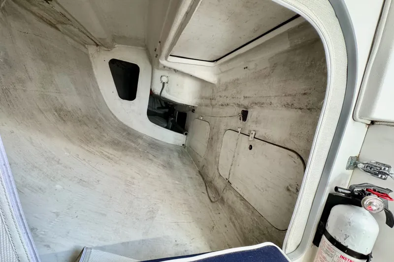 Slide: The Image of Interior view of a 1999 J Boats J/105 sailboat, featuring storage compartments and a fire extinguisher. - 40