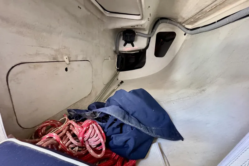 Slide: The Image of Interior of a 1999 J Boats J/105 sailboat with ropes and gear storage. - 41