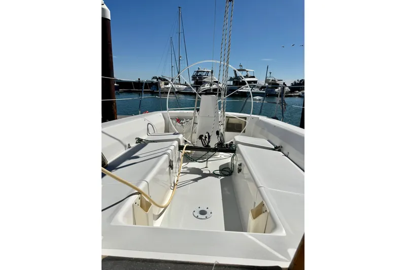 Slide: The Image of 1999 J Boats J/105 sailboat cockpit with steering wheel, docked in marina. - 5