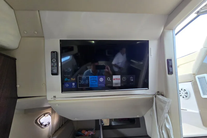 Slide: The Image of 2018 Regal 35 Sport Coupe interior with mounted TV displaying streaming apps. - 19