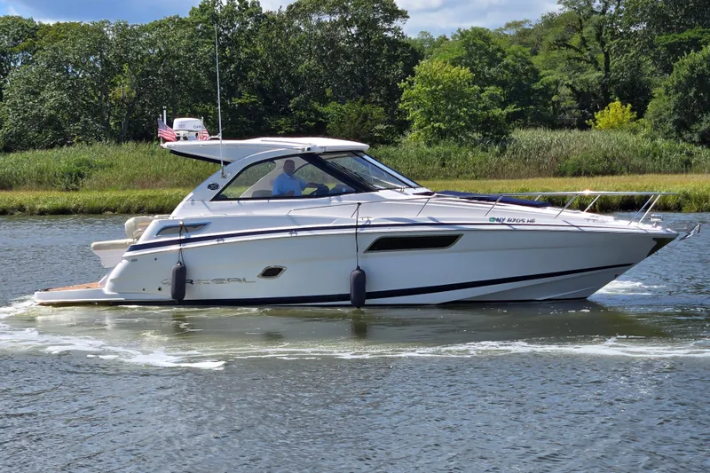 Slide: The Image of 2018 Regal 35 Sport Coupe cruising on a scenic waterway with lush greenery. - 3